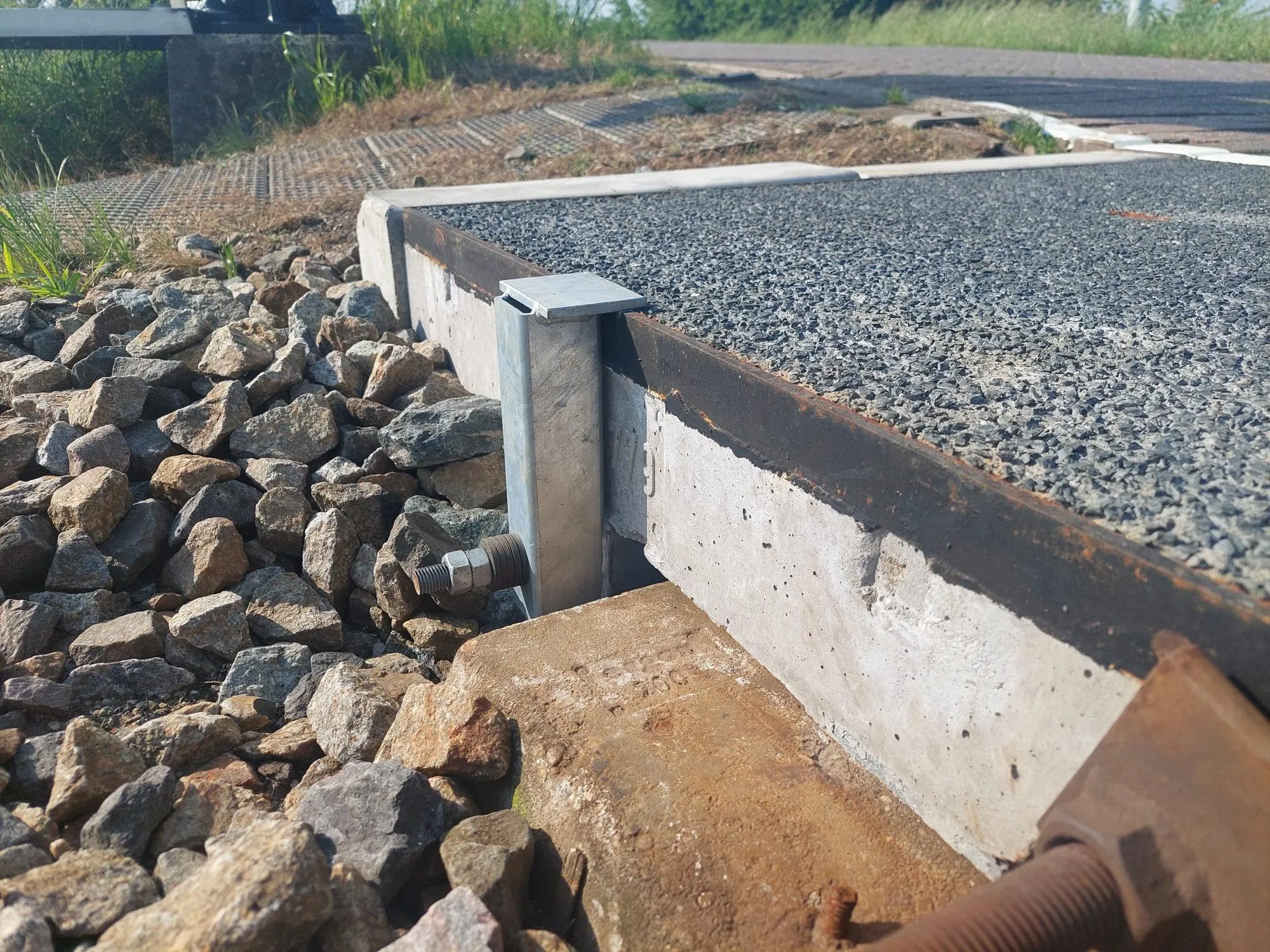 Galvanised NIOP tensioner bolted to the end face of a concrete crossing plate