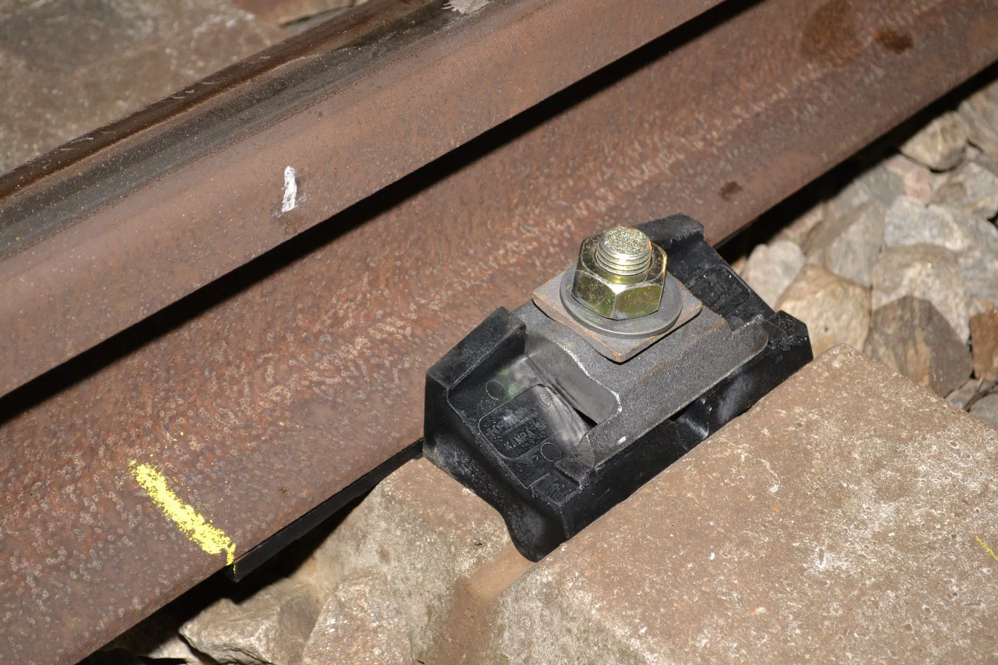 Close-up of a black ShimLift NS90 fastening on a concrete sleeper