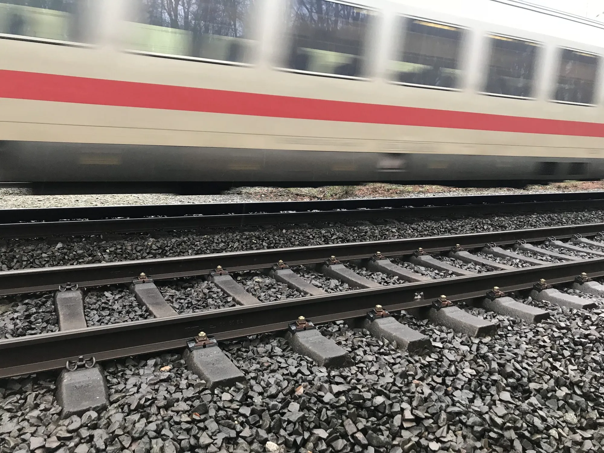 ShimLift NS90 fastenings in the track as a train passes on the adjacent track